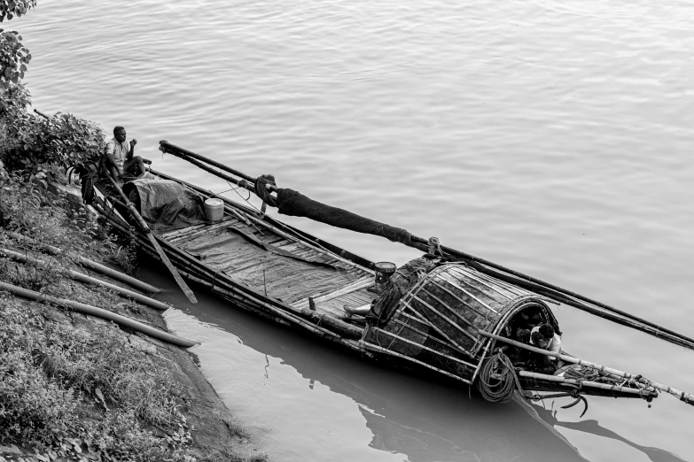 a boat is docked on the edge of a river