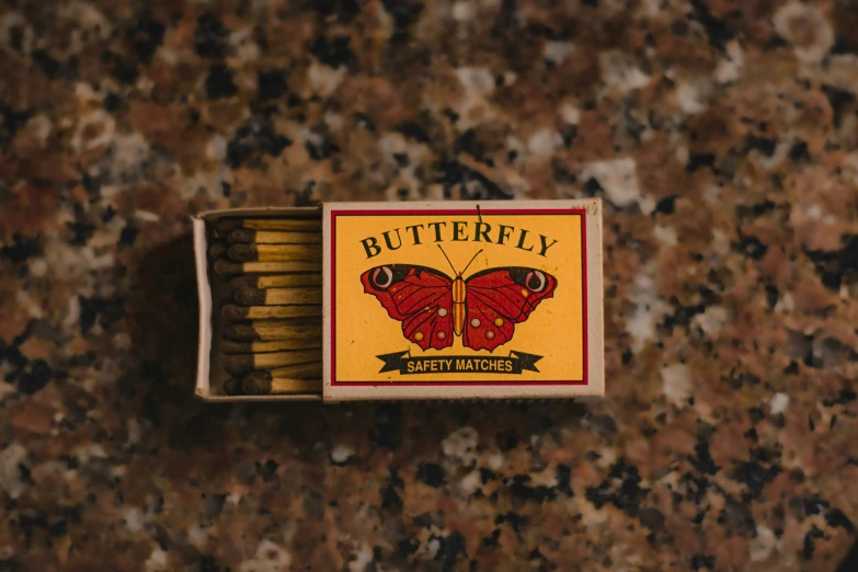 a matchbox is open to reveal the erfly matches