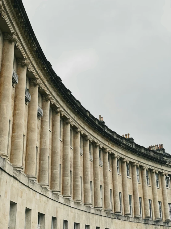 the top of a building with pillars and arches