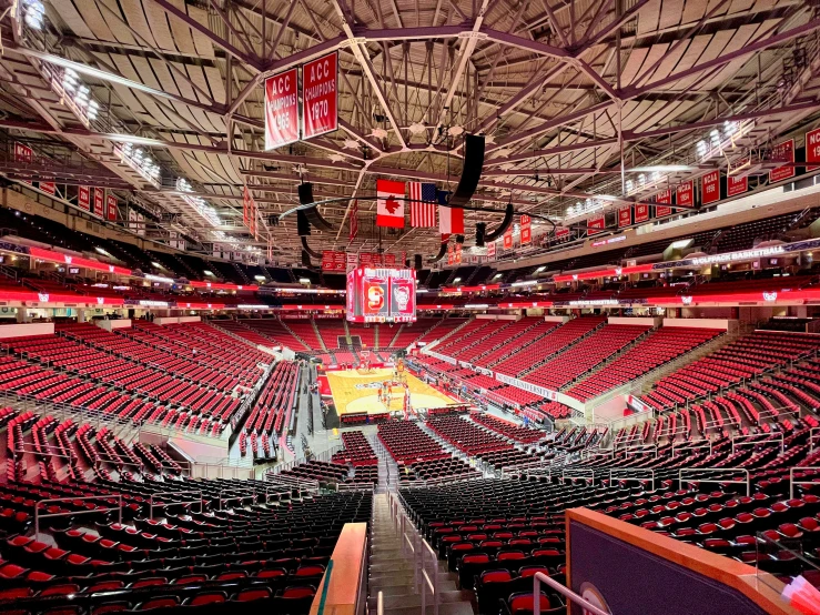 there are many red chairs in this empty sports arena