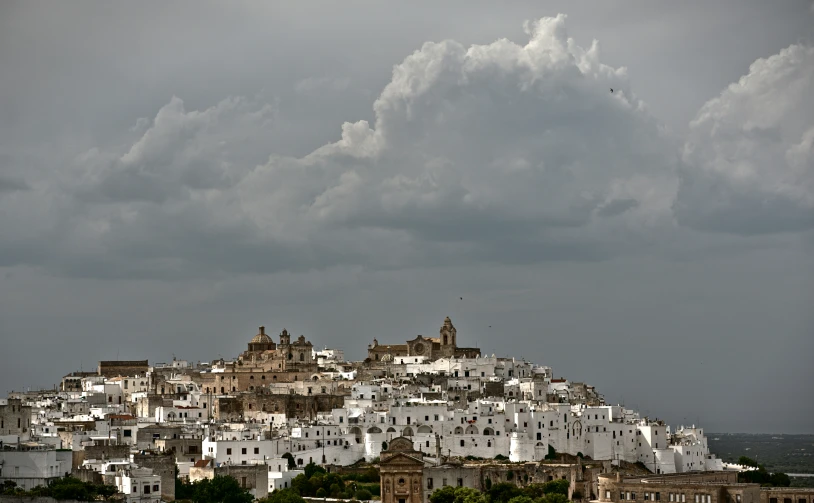 a large city on a hill with white buildings