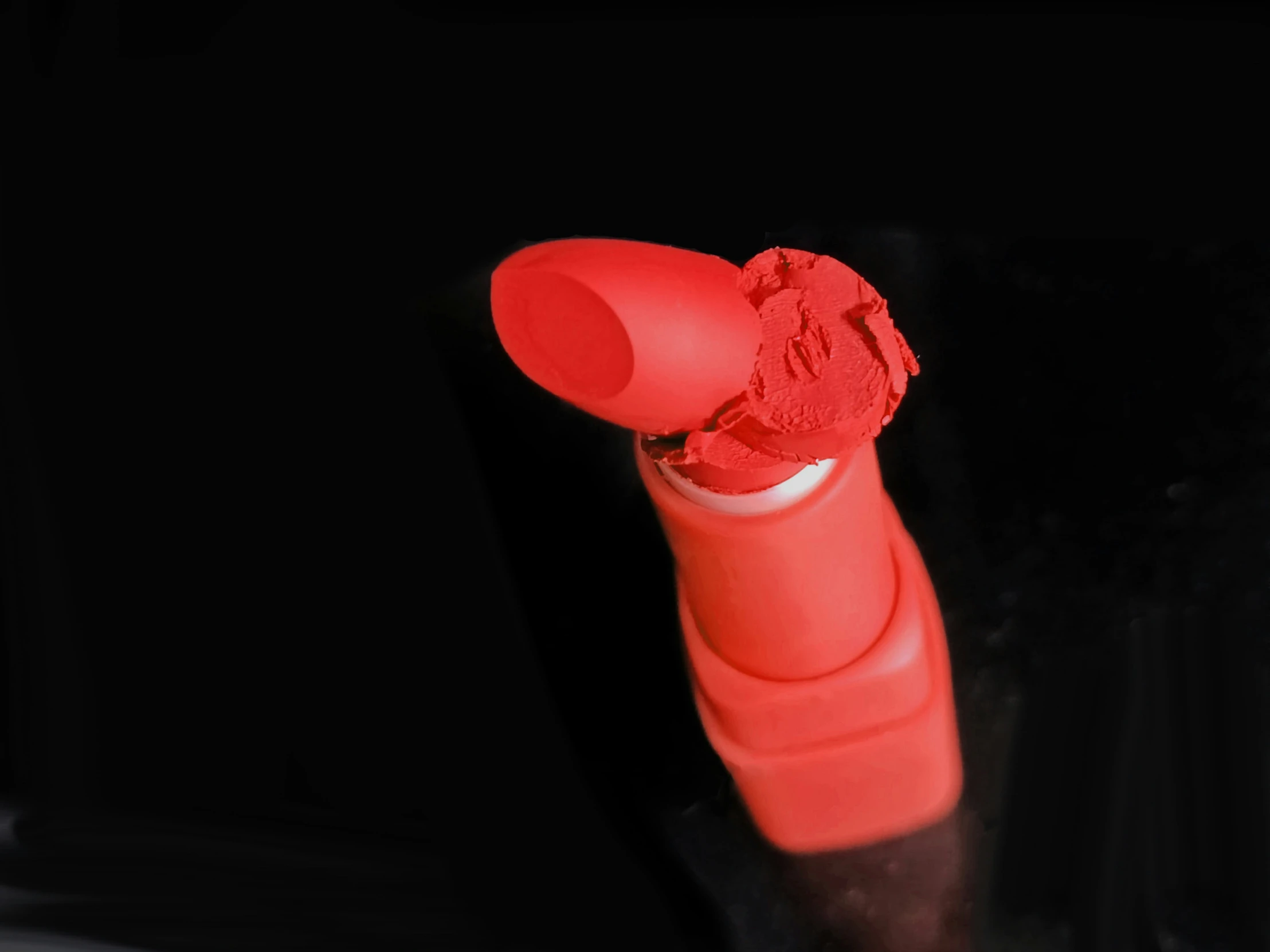 a bright orange tube with the red tip in between it's edges