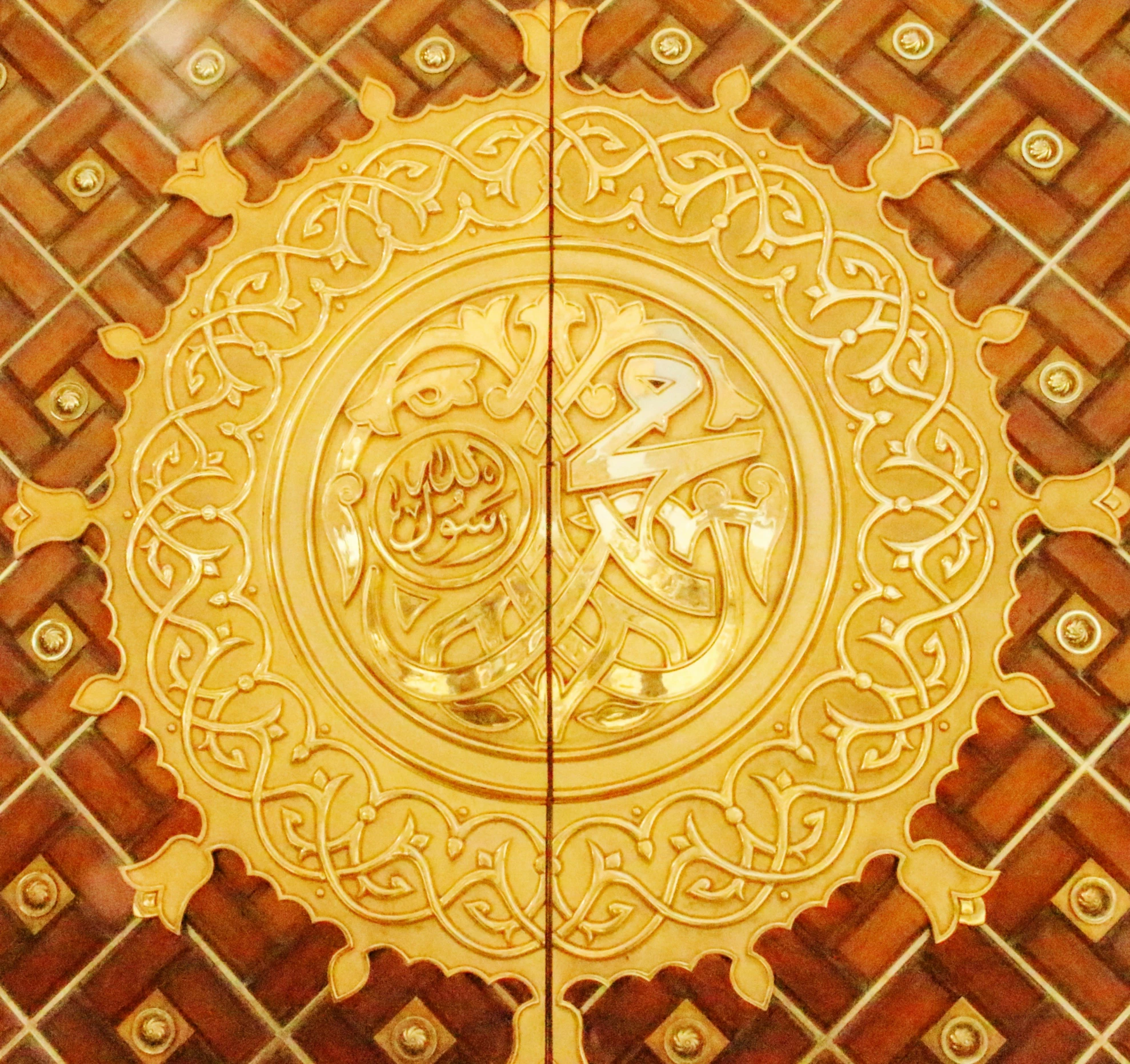 there is an ornate gold plate on this wooden floor