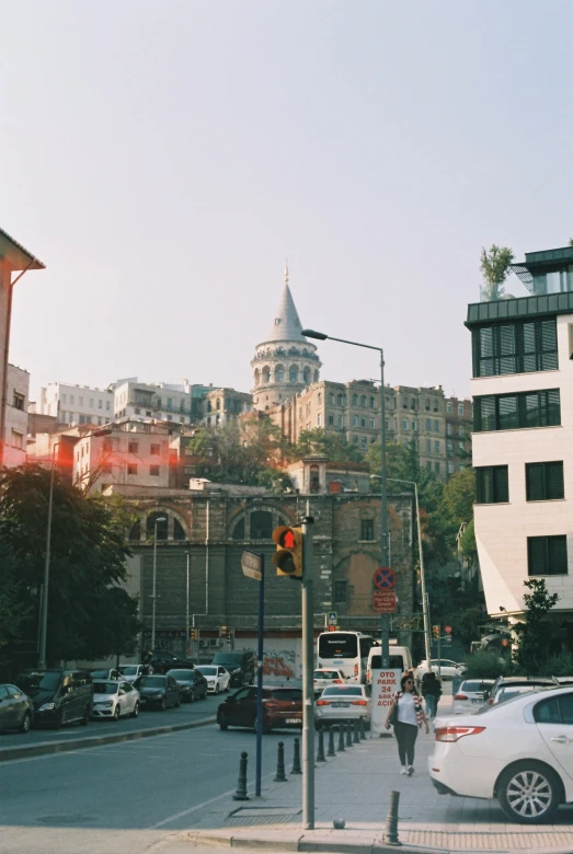 people walk through a quiet, street with tall buildings