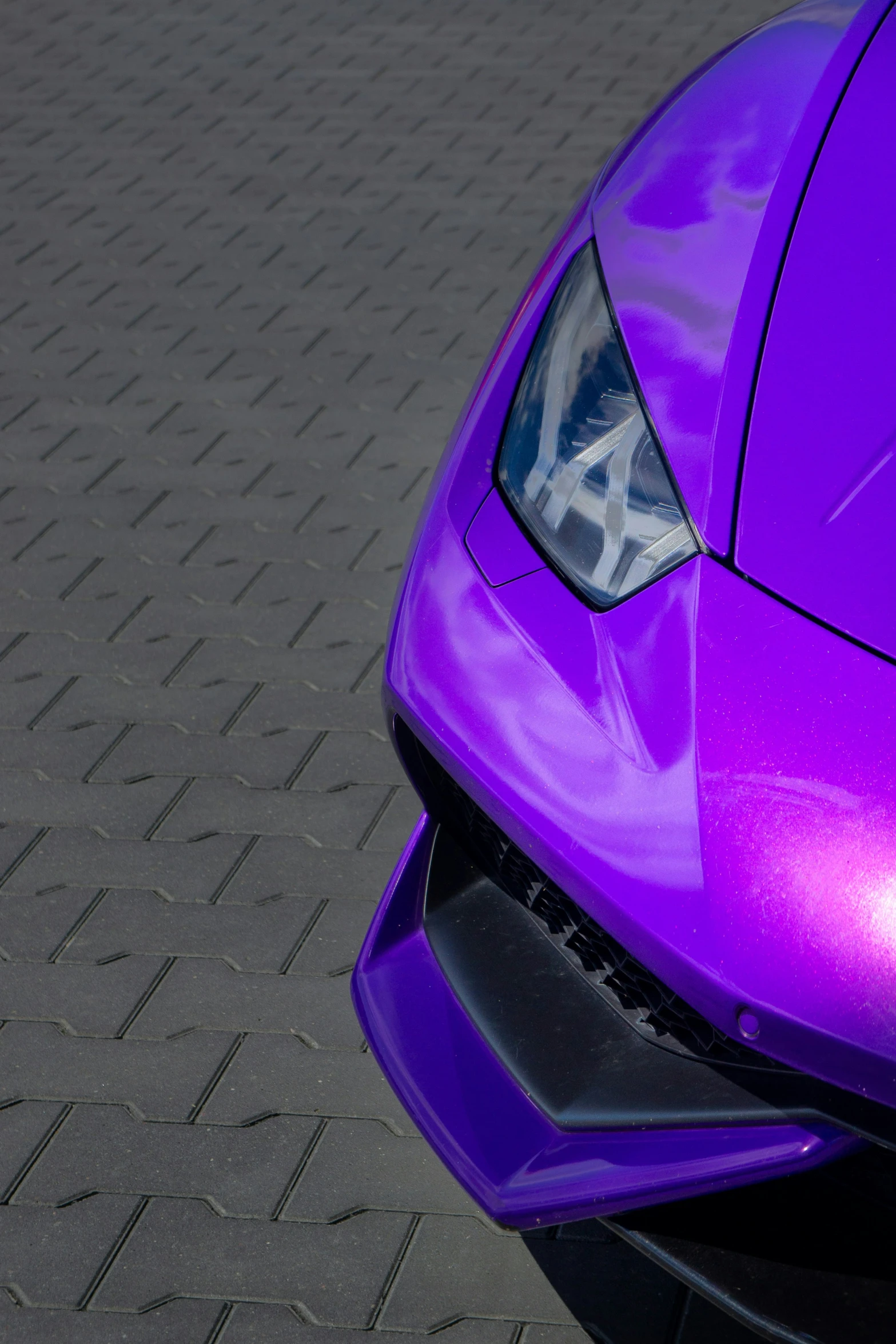 the front end of a purple sports car