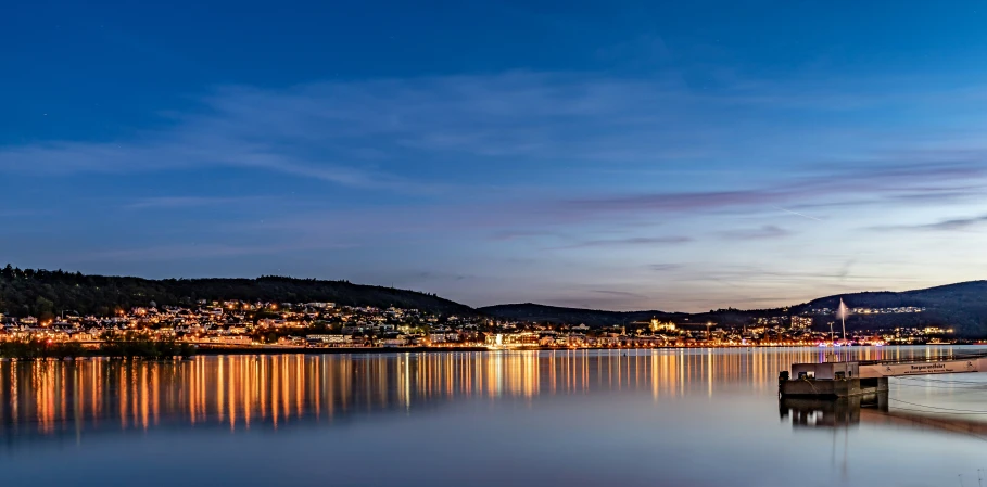 night time at the shore of a small city by a lake