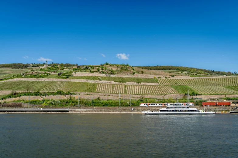 the view of a boat parked near a large hill