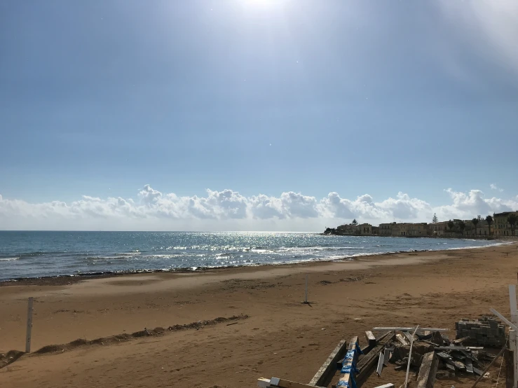 a bench on a beach with water in the background