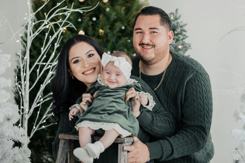 a family posing with christmas tree and presents