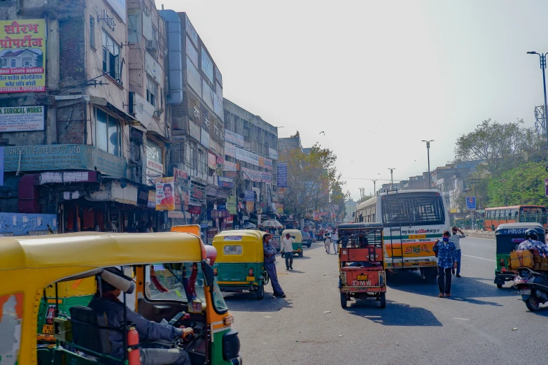 several motor cycles drive down the busy city street