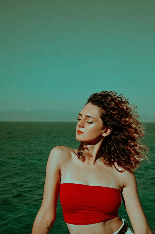 woman standing on a boat at sea looking off into the distance