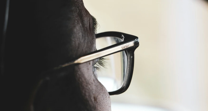 a close - up po of a eyeglasses resting on the arm of a horse