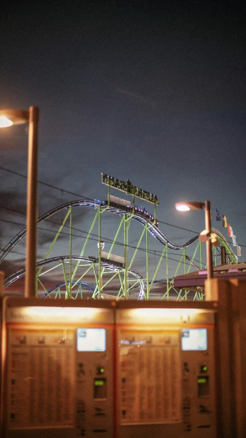 a roller coaster is shown in an empty park at night