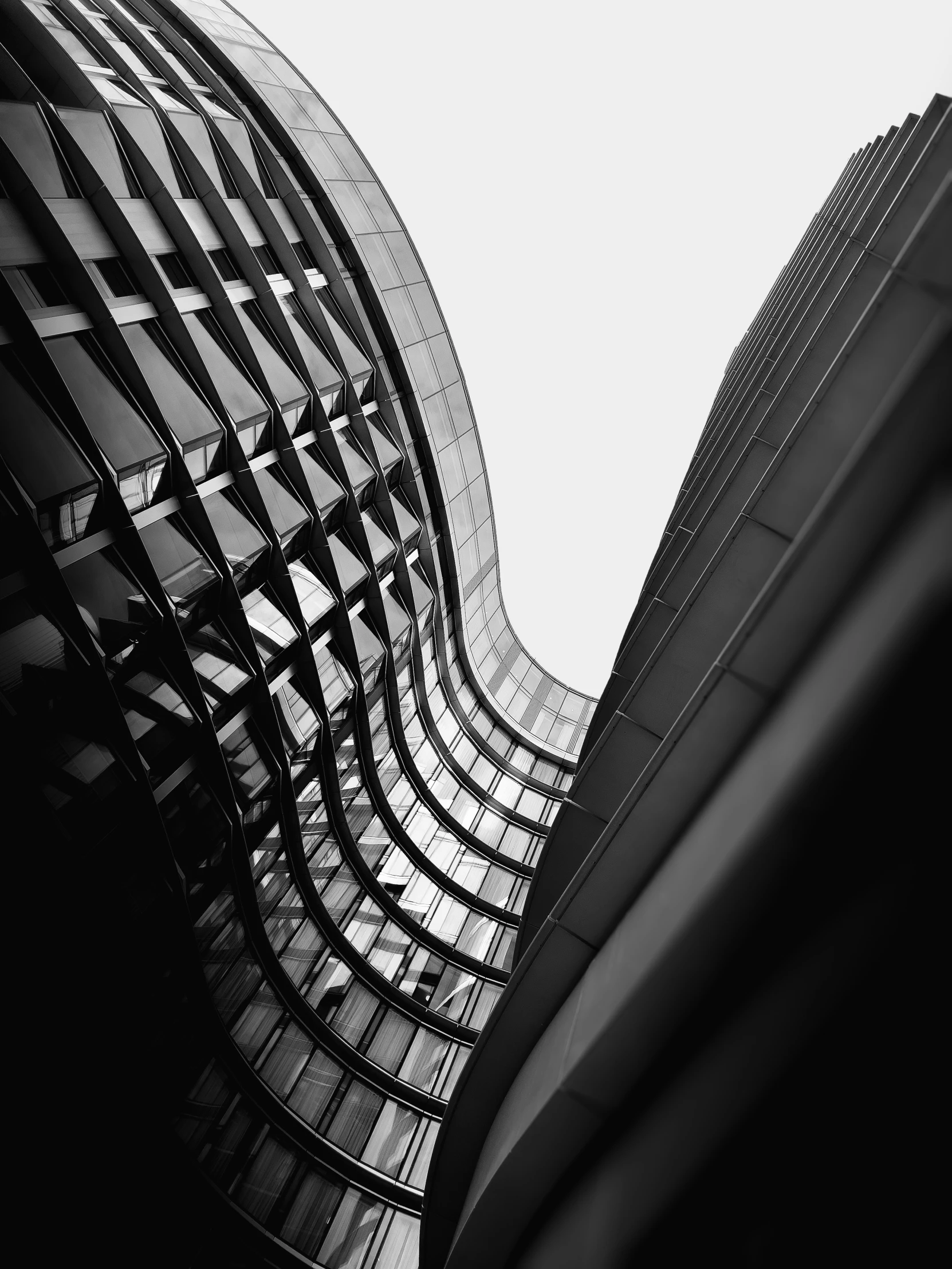 black and white image of two buildings with very high ceilings