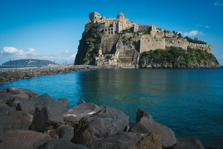 an ancient castle on a rock shore