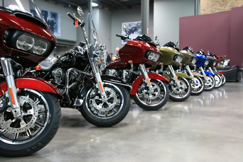 a row of motorcycles parked inside of a building