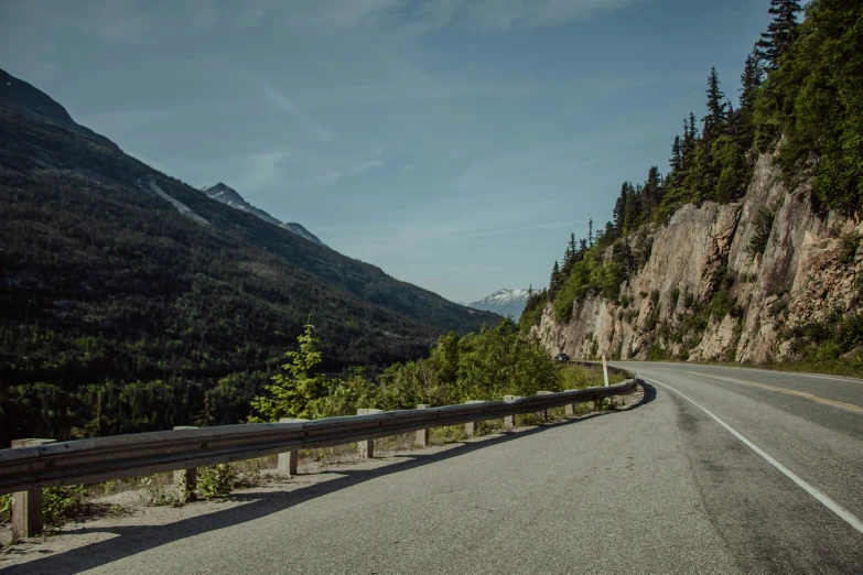 a long road with mountains in the background