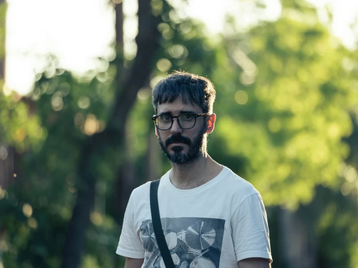 a man standing in the woods in glasses