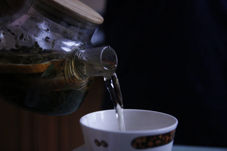 pouring a glass of coffee from an old pitcher