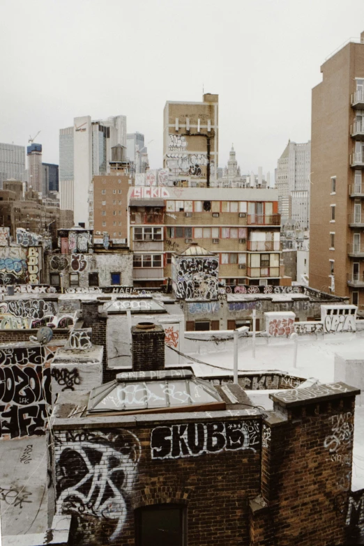 some very old buildings covered in graffiti and snow