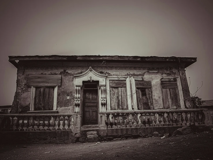 an old abandoned house with a rundown balcony