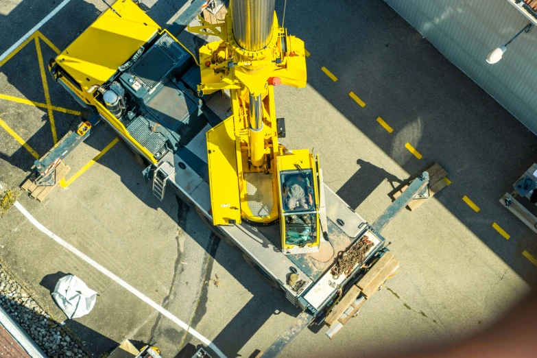 a yellow work area with some machinery and a car