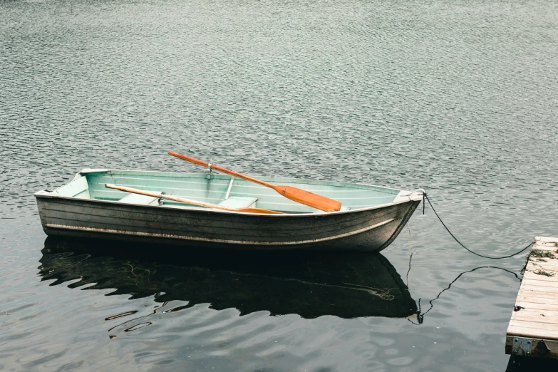 the small boat has three oars attached to it