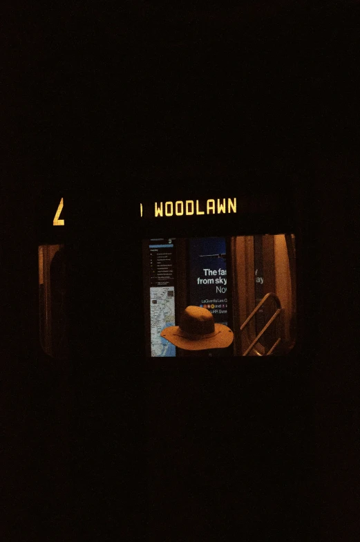 a lit up door way at night with a menu in the distance