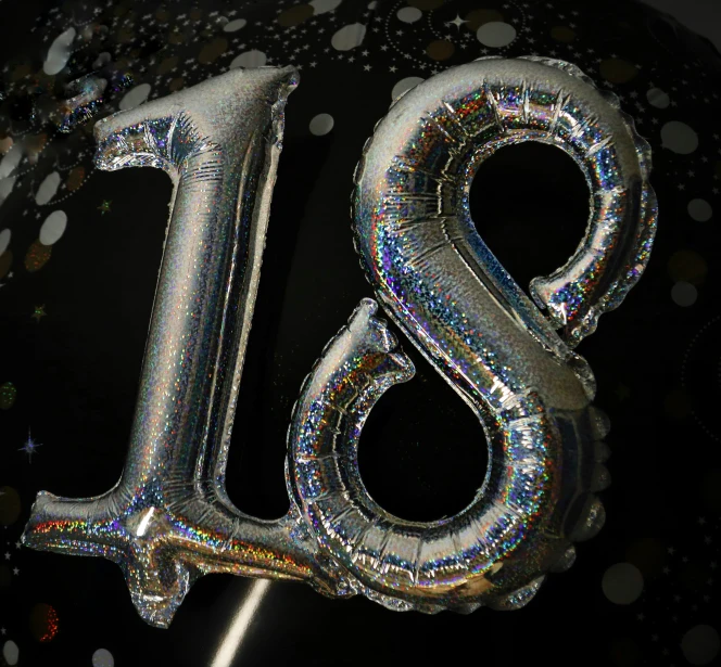 a number eighteen balloon sitting on top of a balloon