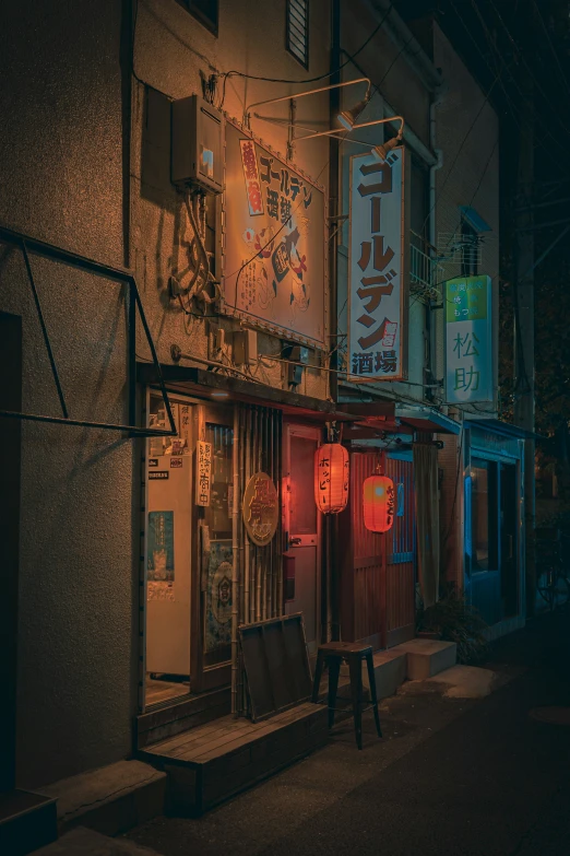 a street sign and street lamp displayed at night