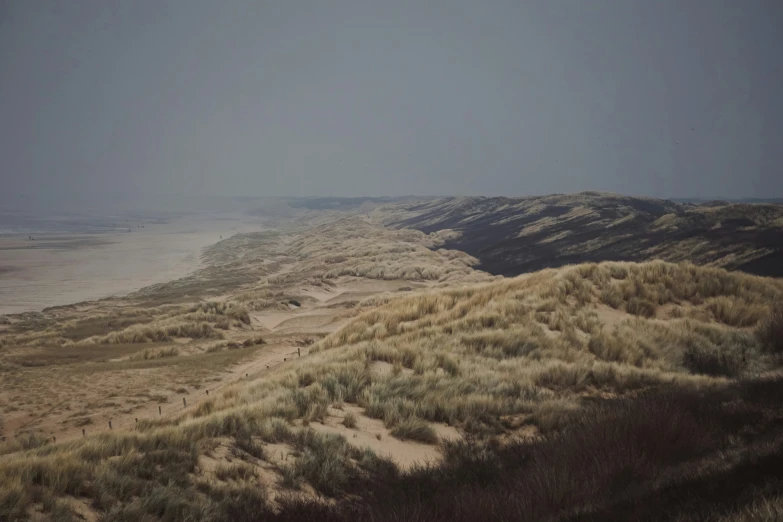 a grassy area on a hill covered in dirt