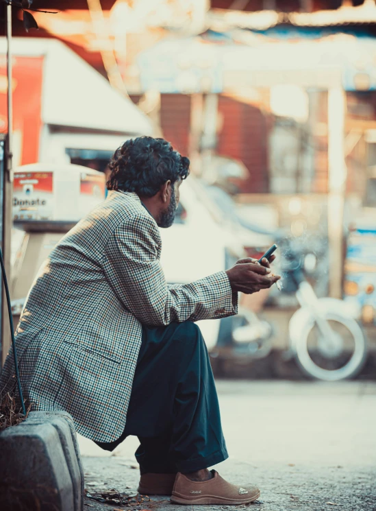 an old man holding a cup sitting on top of his stomach