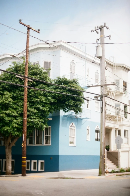 a street corner has blue and white homes on the side