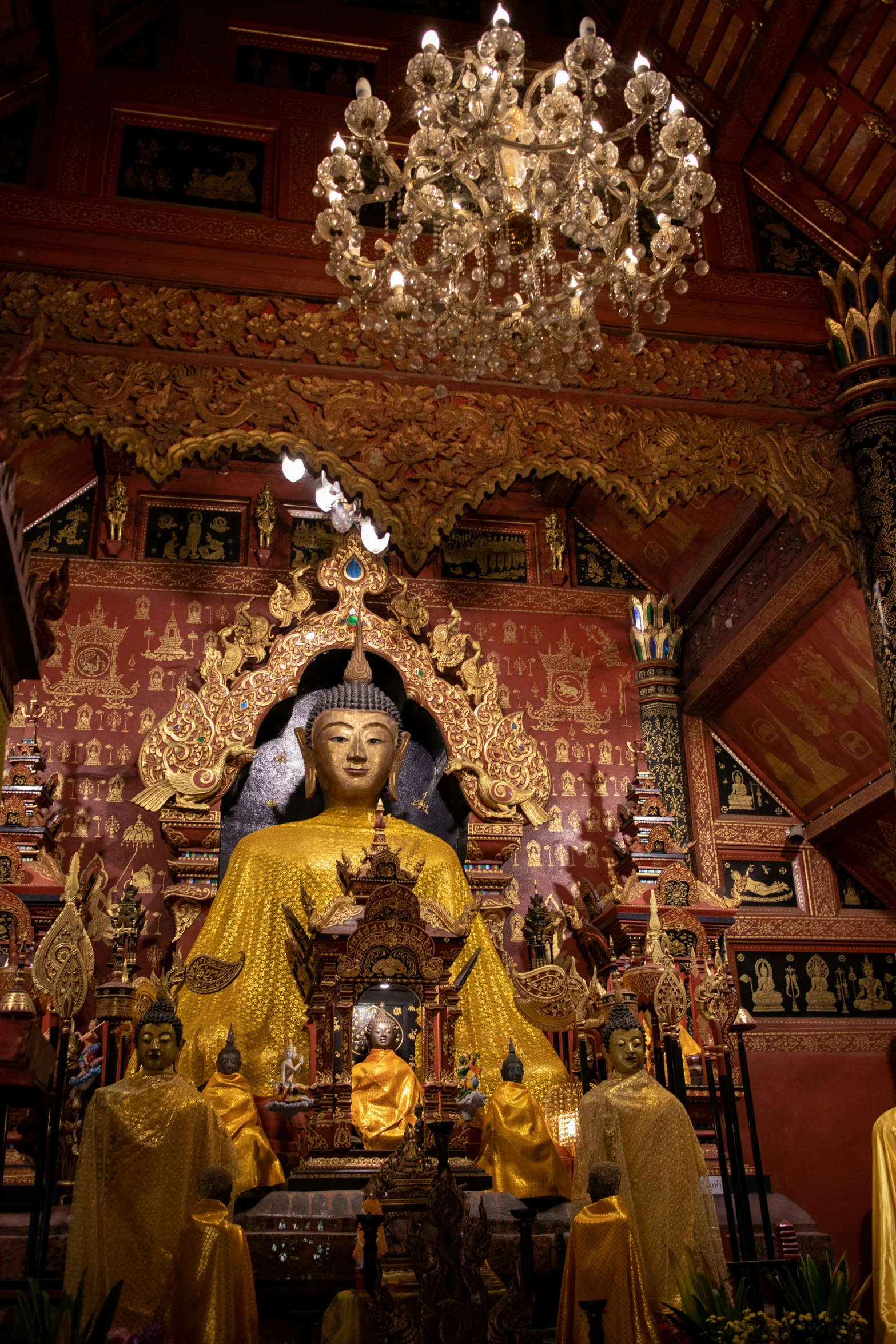 a large golden buddha statue is in a shrine