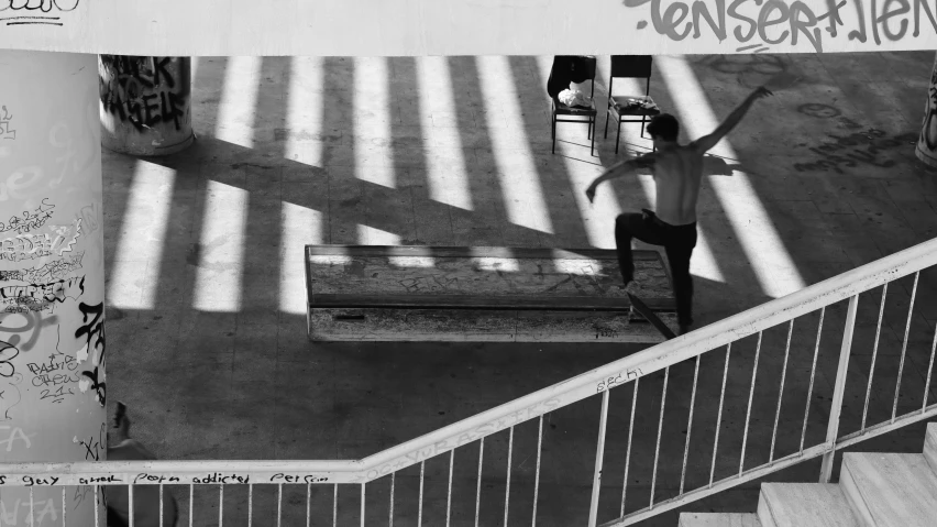 man standing on steps in black and white pograph