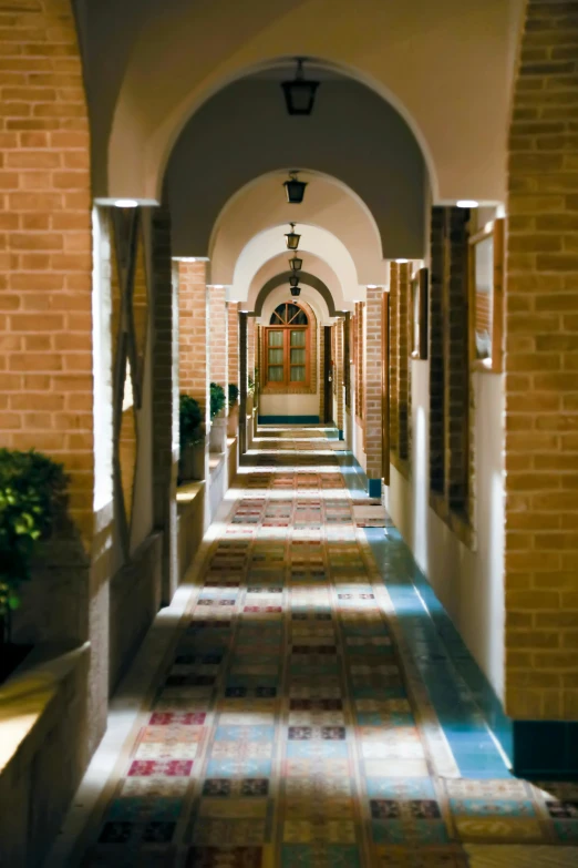 there is an arched hallway with many windows and a tile floor