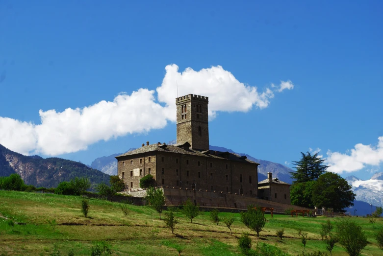 an old brown house with large stone steeples on top