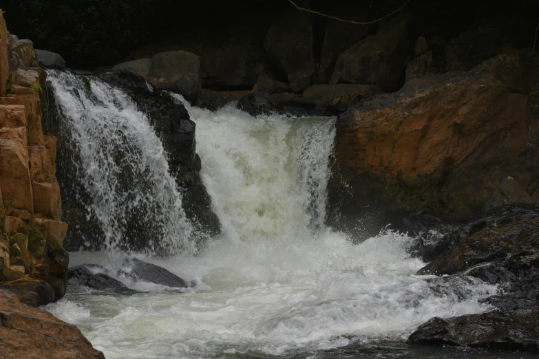 a waterfall that is flowing over some rocks