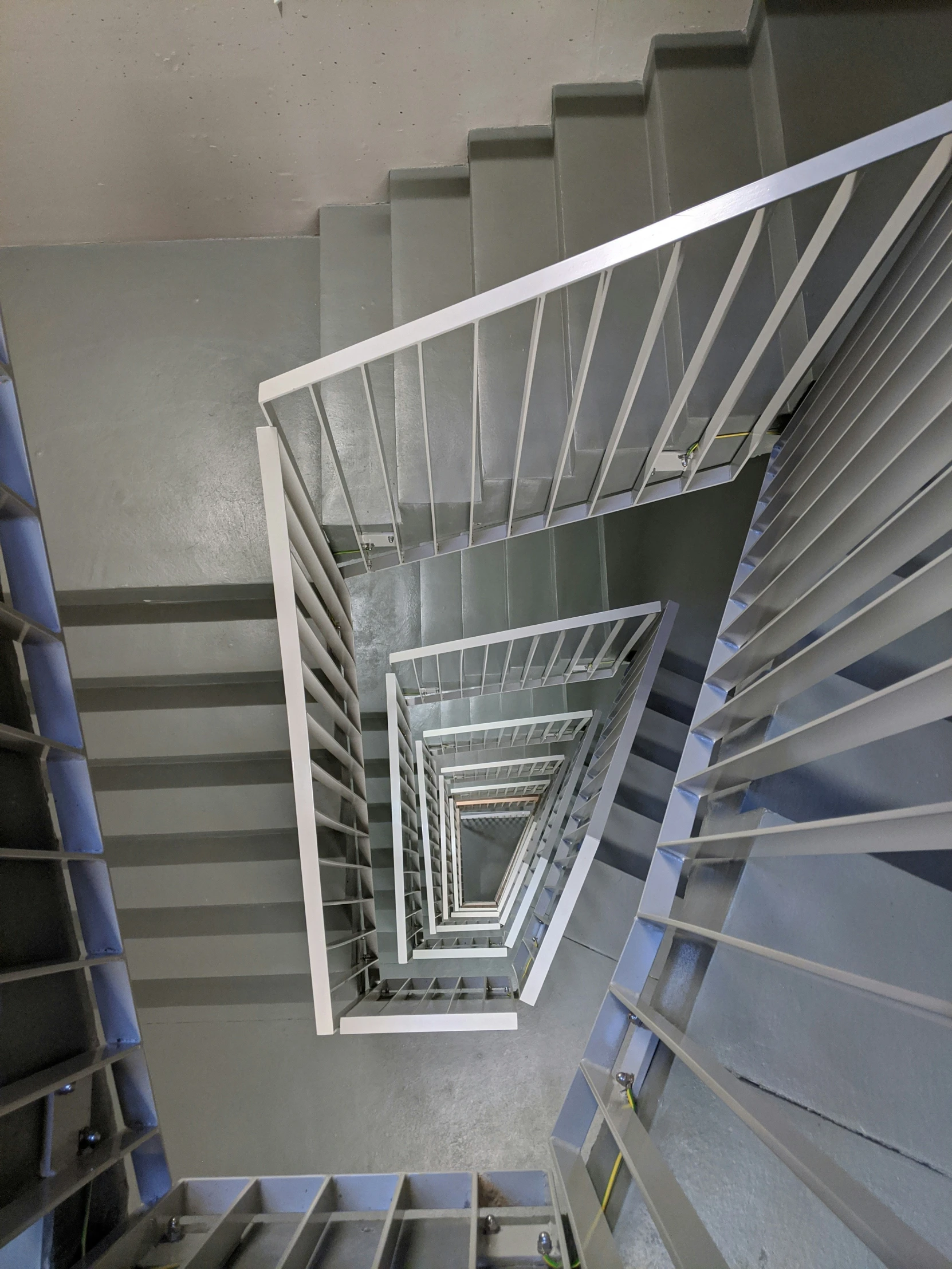 a very long and wide staircase made up of glass balconies