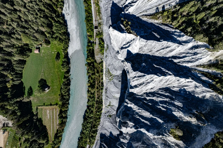 an aerial view of a valley with snow capped mountains in the background