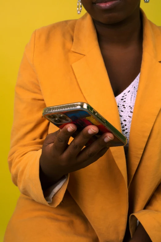 an african american woman with dark skin and large earrings holding an electronic device