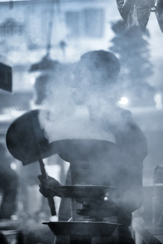 a person that is cooking in some kind of pot