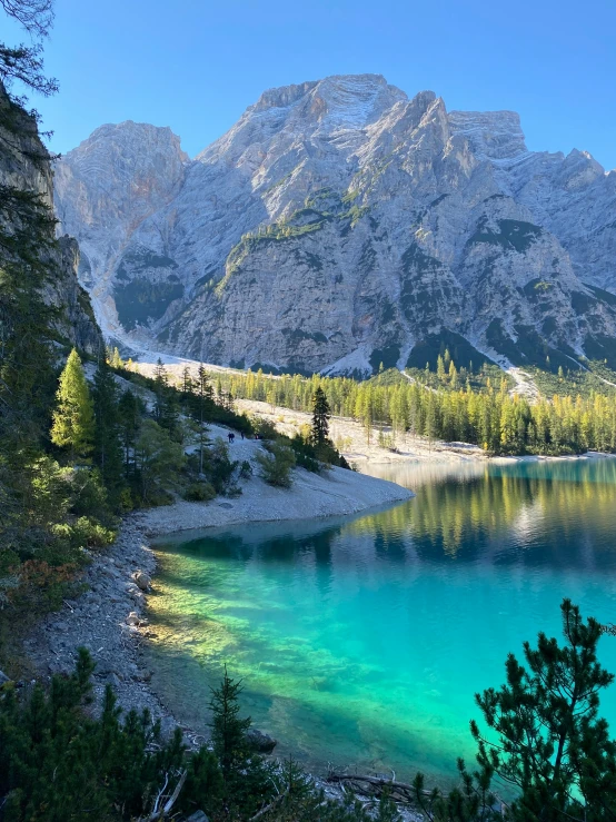 a lake that is very blue with some green water