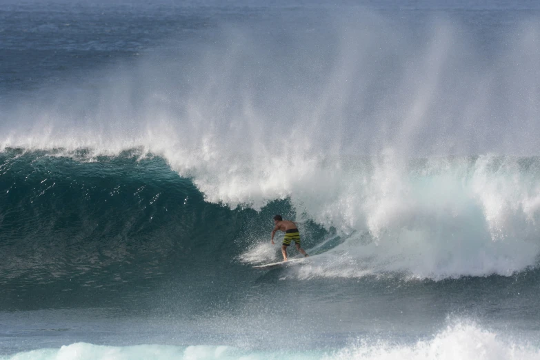 a surfer riding a big wave in the ocean