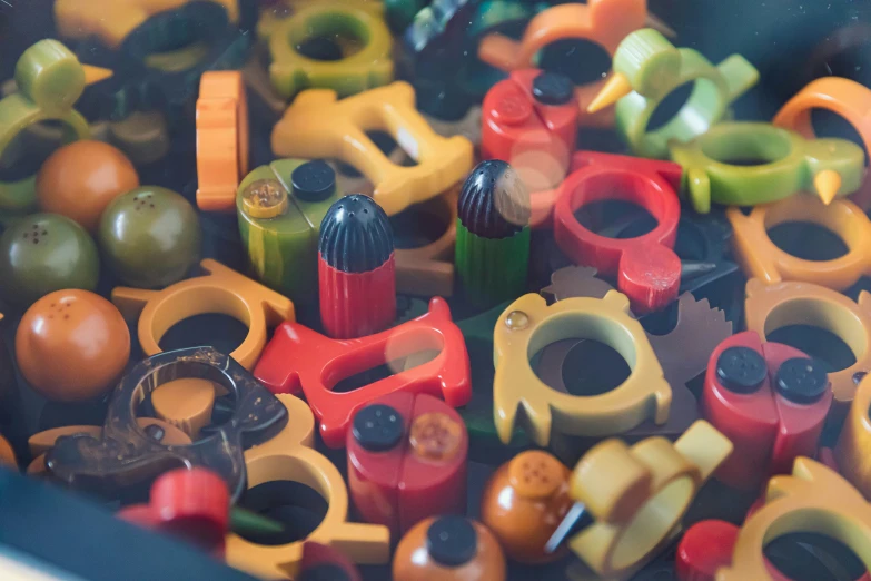 a pile of small toy blocks and toys with scissors