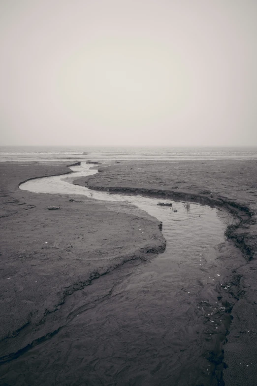 a small stream is running through some sand