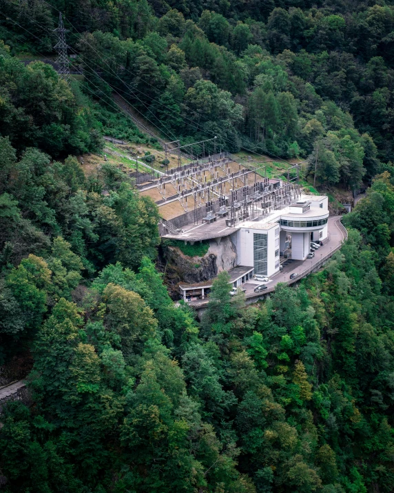 a large circular structure on the side of the hill in a forest