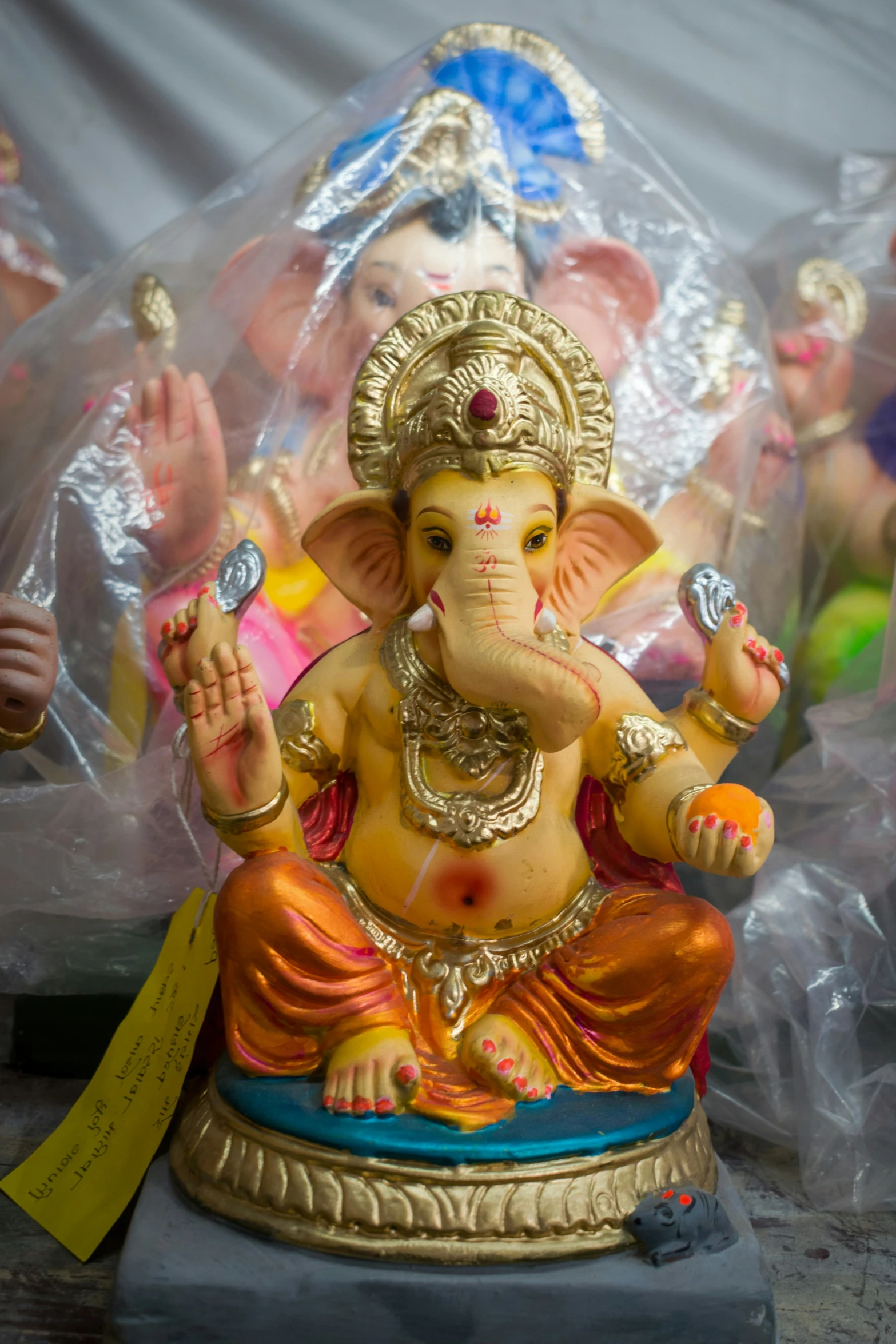 an elephant god statue on display inside a tent