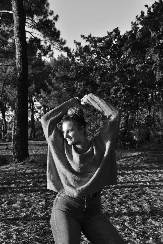 black and white pograph of a person doing yoga exercises in a park