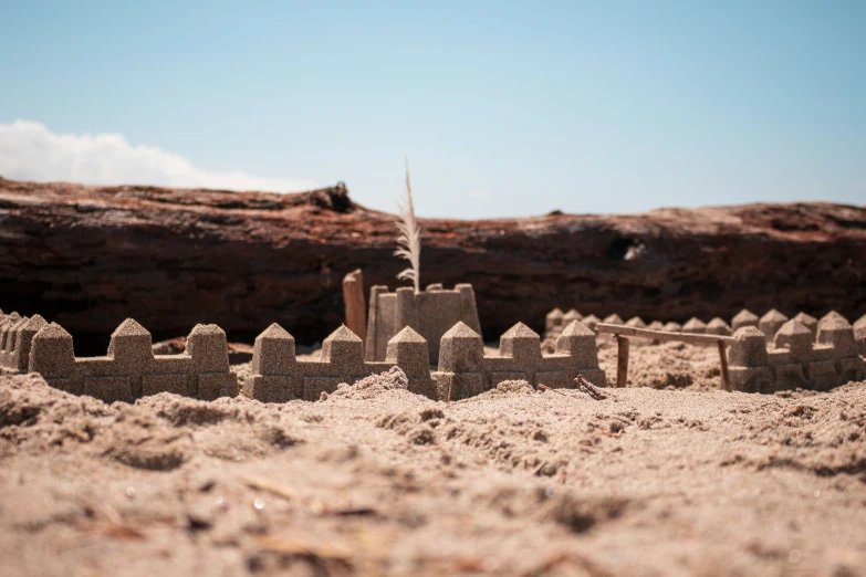 a sand castle sitting on top of a sandy beach